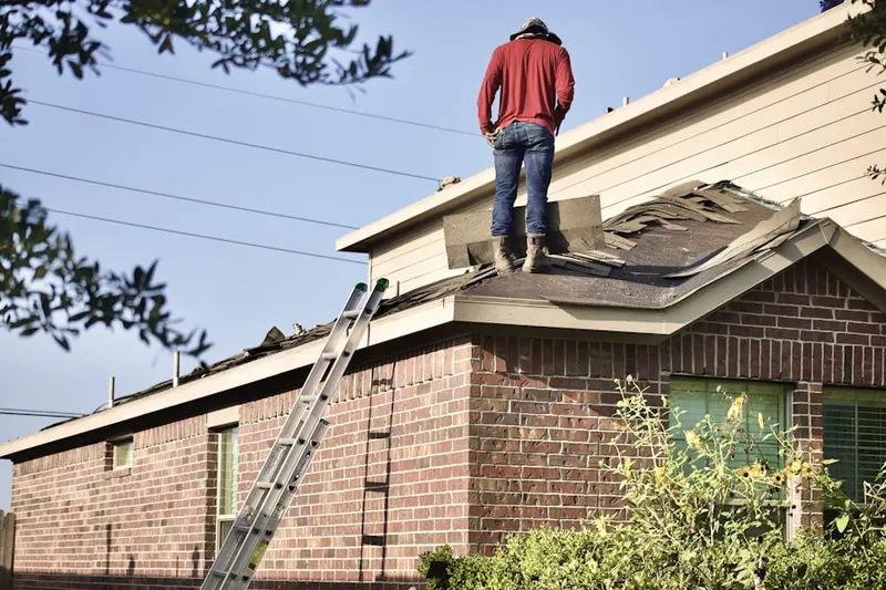 Professional roofer working on a residential roof in Table Mesa North